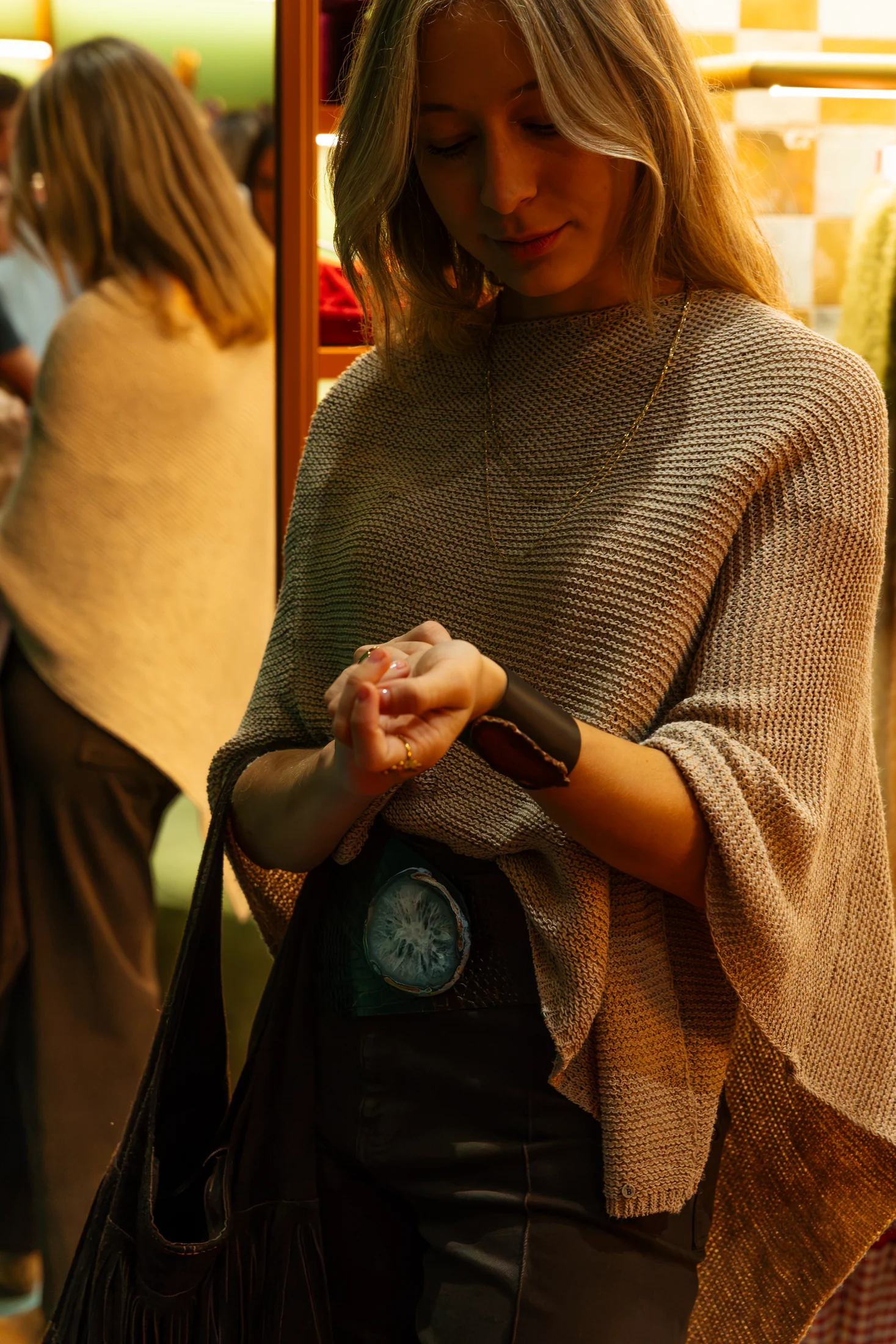 Guest trying on a Balasoir cuff during the in-store event, photographed by Ludovic Delot