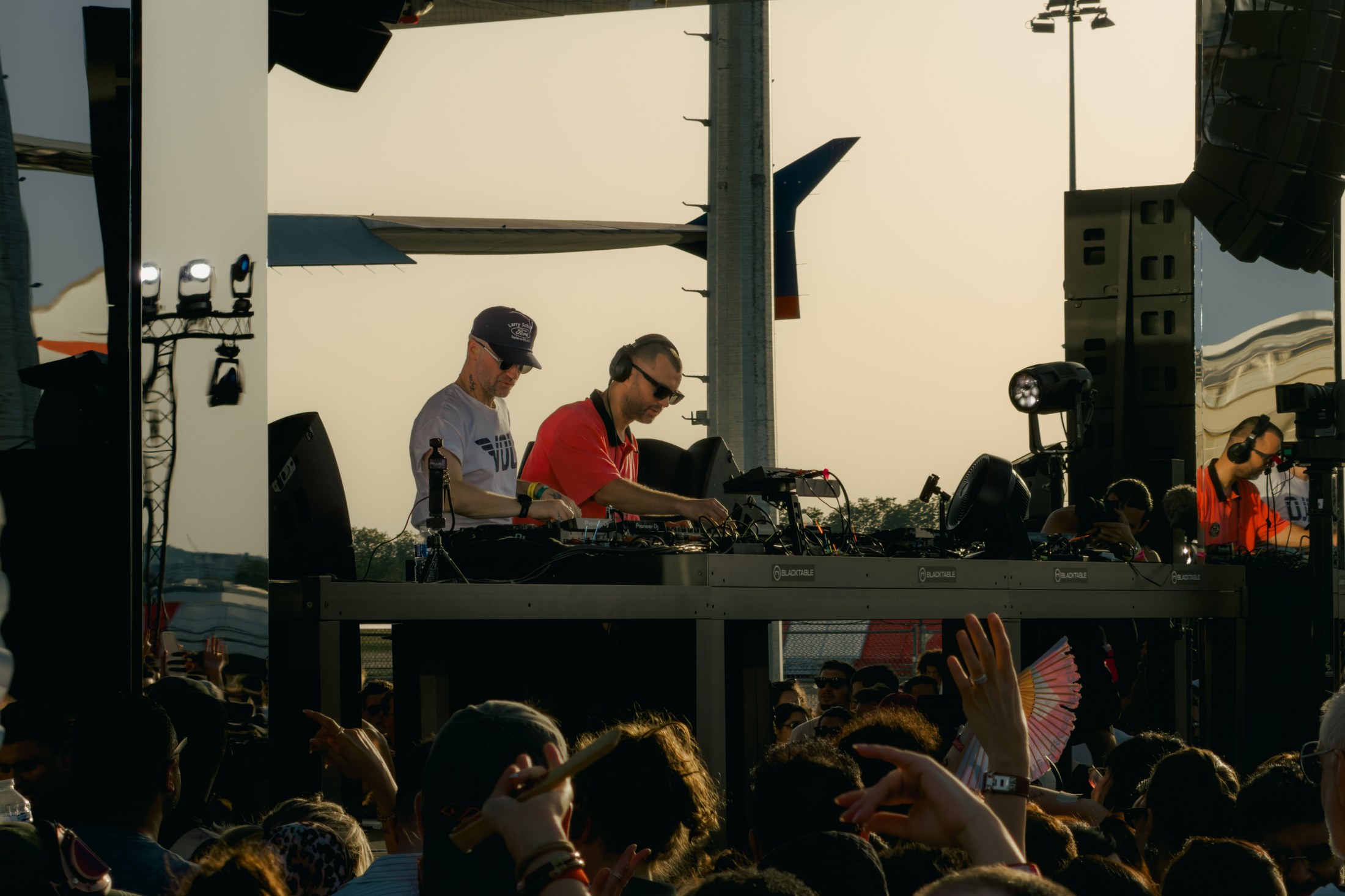 A shared set against the airfield backdrop, photographed by Ludovic Delot